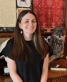 Jess, a white woman with long brown hair, smiles at the camera.